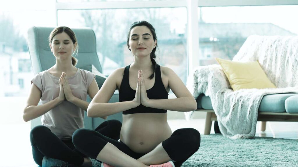 two pregnent mums in prayer position for yoga