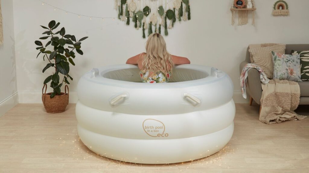 white eco birth pool in a box set up with a woman in pool.