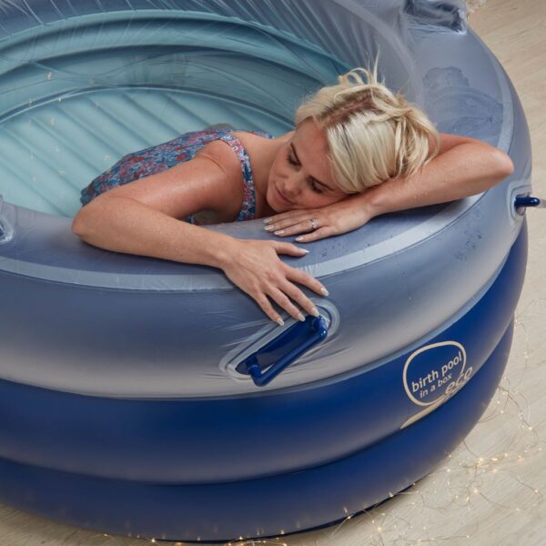 mum relaxing in midnight blue birth pool